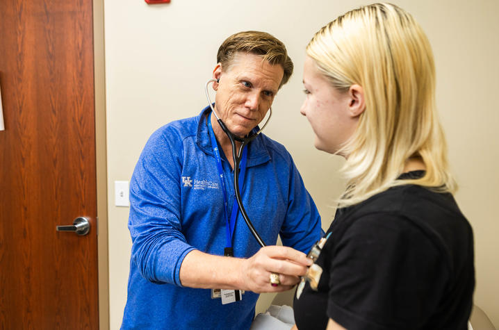 Image of Dr. Bezold listening to Annastasia’s heart