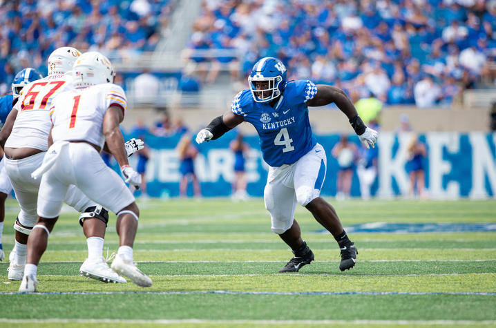 Action shot of Josh Paschal on the football field.