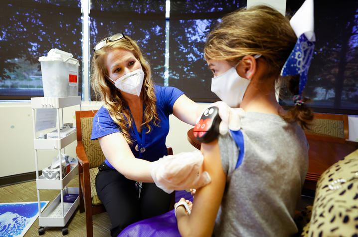 Doctor giving a pediatric patient a shot