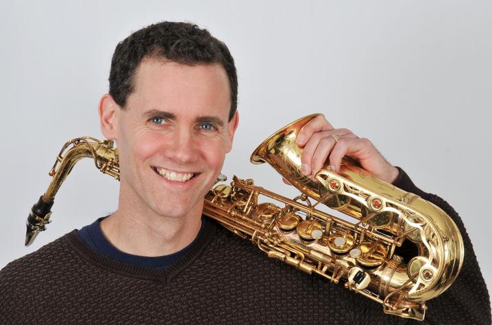 headshot photo of Rick Hirsch with saxophone by Meadowlane Photography