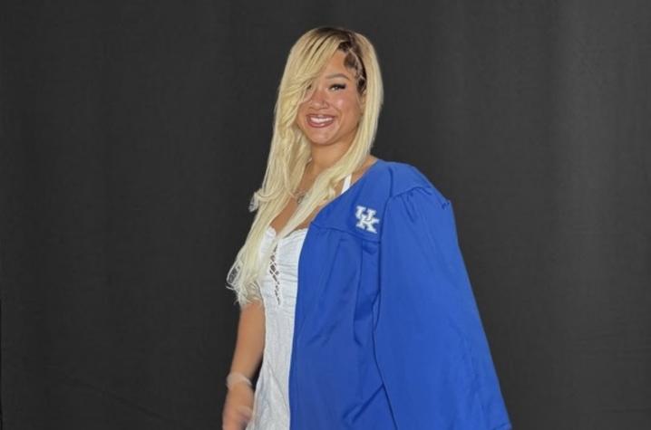 ShoShana White standing with her graduation gown.