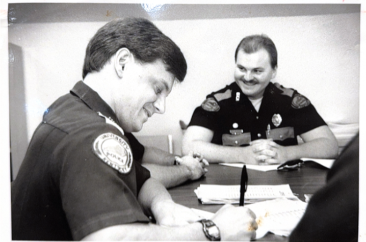 an old photo of young officer saylor conducting a role call on a shift