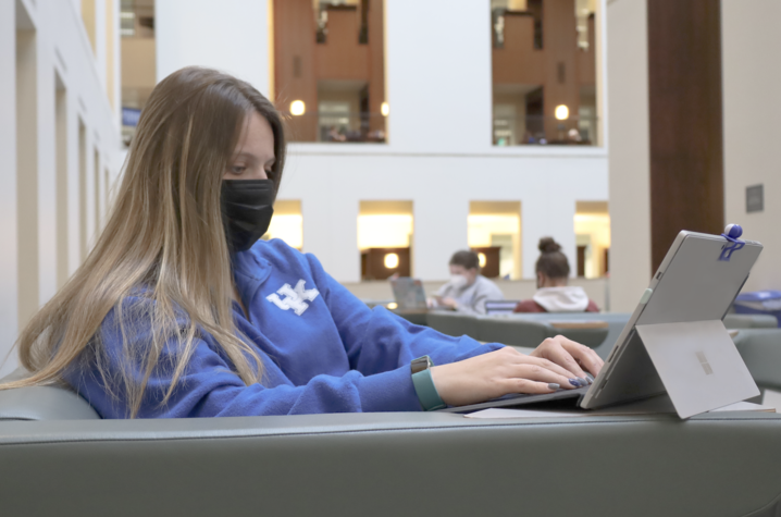 Student using tablet device in William T. Young Library on UK campus
