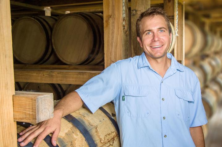 photo of Seth Debolt among bourbon barrels