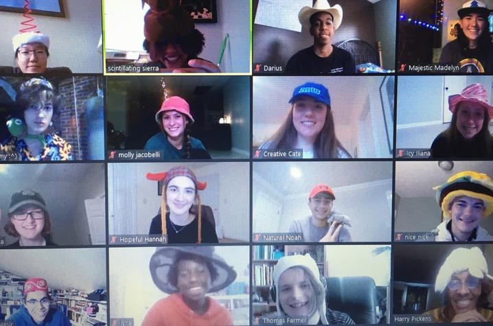 photo of 16 screens of GSA students in hats as part of an RA group meeting