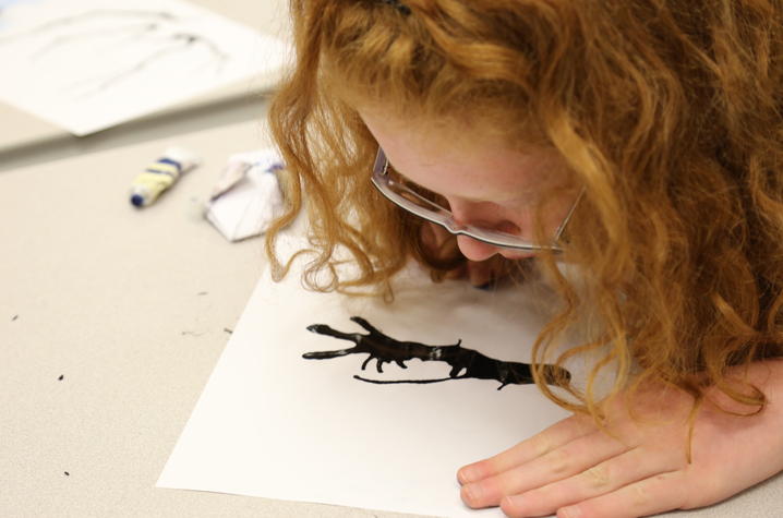 photo of student working on art at  2 kids eating at UK Confucius Institute Spring Break Camp