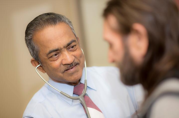 photo of Dr. Roy Varghese with a patient