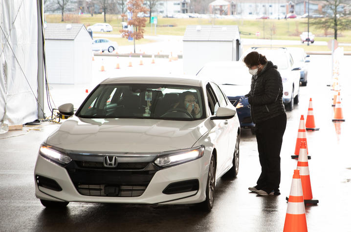 Student in a car in line to be tested for Covid-19 by an employee of Wild Health, UK's partner in Covid testing, in the Kroger Field drive-thru testing location.