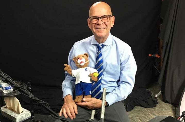 photo of T. Lynn Williamson with Wildcat doll after oral history interview