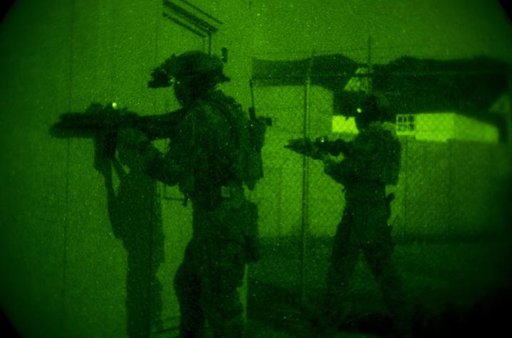 U.S. Marine Corps Forces, Special Operations Command provide security during a night raid. Photo By Cpl. Steven Fox