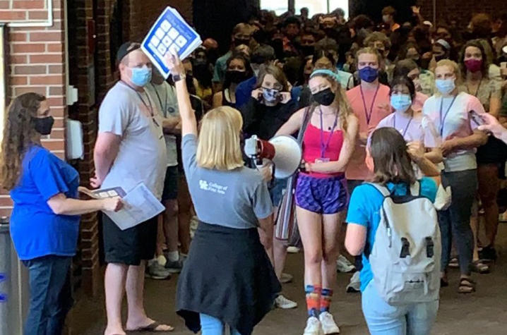 photo of Emma Lucas directing masked GSA 2021 students out of Singletary Center