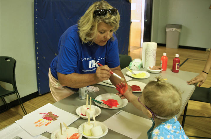 UK student helps kid fingerpaint 