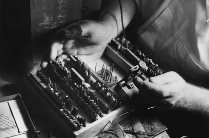 black and white photo of Victor Hammer's hands working on a press