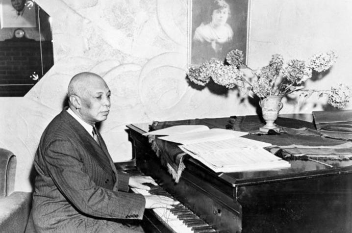 black and white photo of WC Handy playing piano in Henderson
