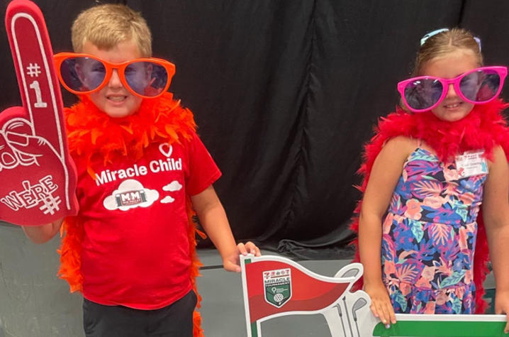 Image of child in red t-shirt with red novelty foam finger