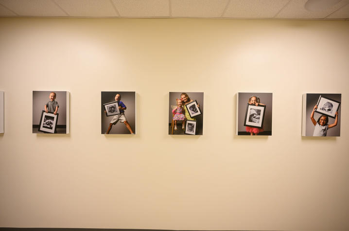 image of portraits of children holding their baby photos from when they were treated in the NICU