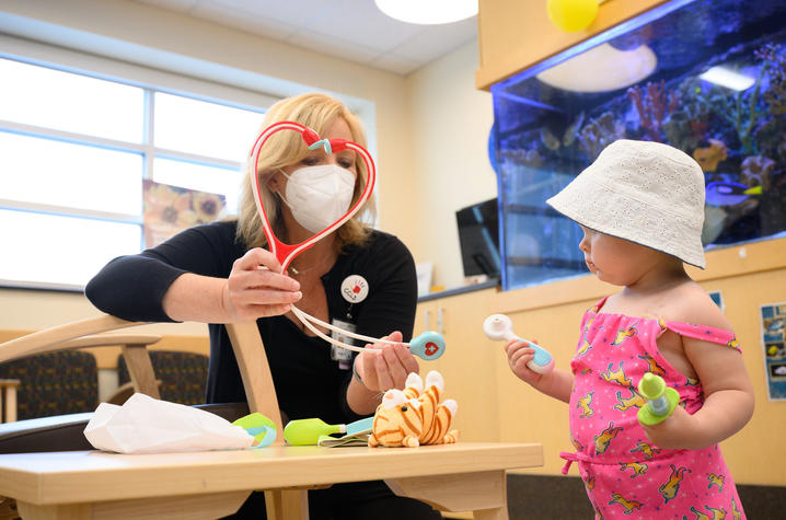 Image of Guilliams playing with child