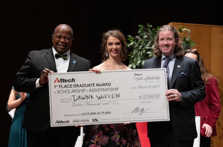 photo of Everett McCorvey, Dawna Warren and Mark Lyons with Dawna's large scholarship check