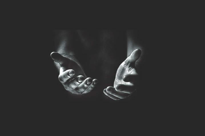 black and white photo of hands reached out