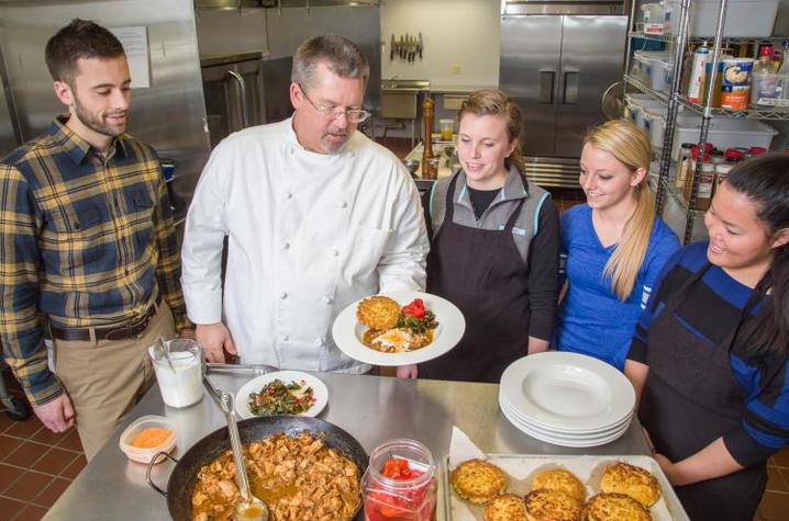 Faculty member Aaron Schwartz, Chef Bob Perry plates a meal with students