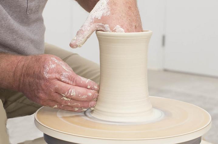 photo of hands working on ceramic vase - Fine Arts Institute