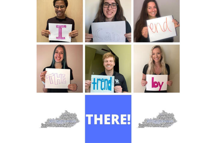 photo of students holding up signs