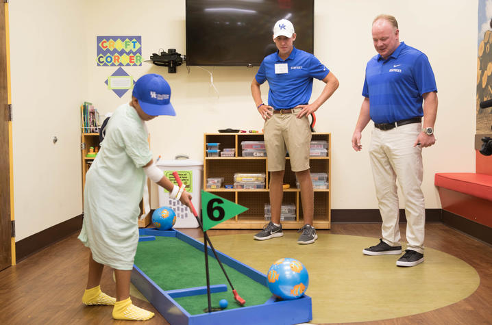 Patient golfing with Coach Stoops and UK golf player