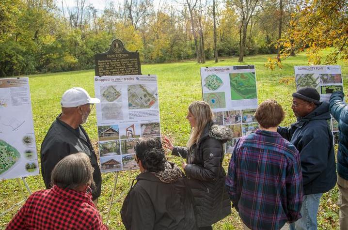 A group of students show their design proposals to community leaders