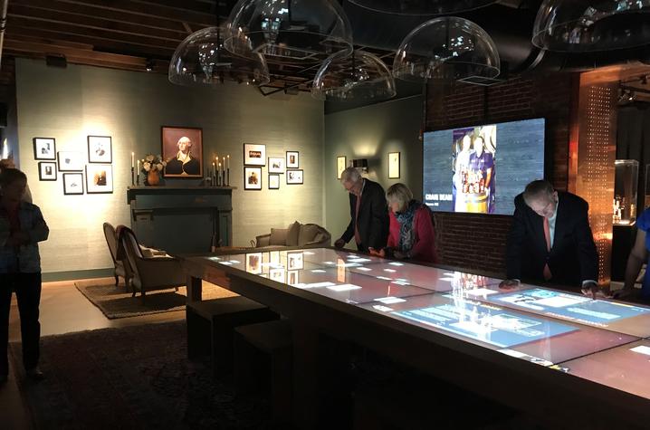 photo of people using interactive table in Gracious room of Kentucky Bourbon Trail Welcome Center
