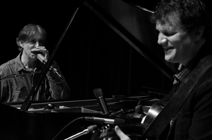 black and white photo of musicians Howard Levy playing harmonica and Chris Siebold on guitar
