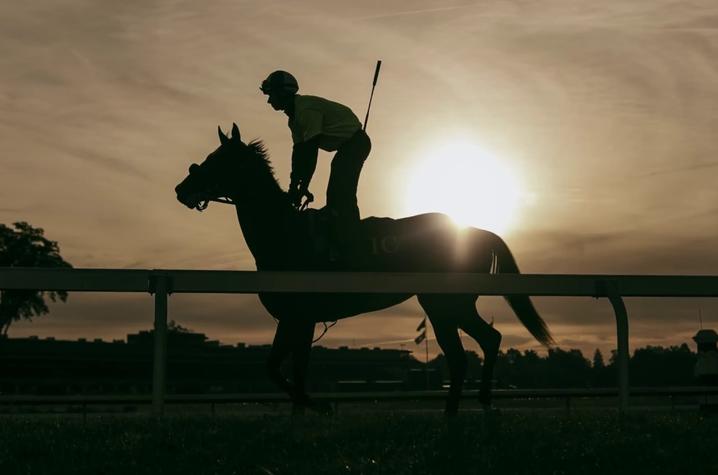 silhouette photo of horse and rider at Keeneland