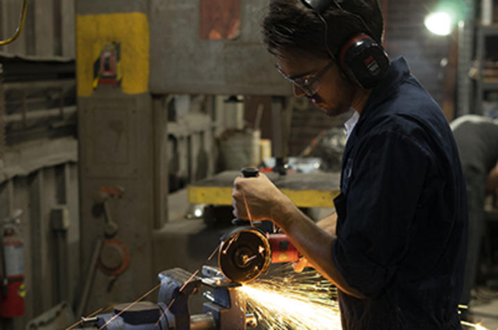 photo of man working in metalworking class