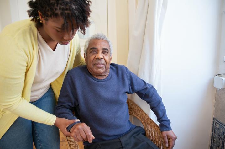 Woman helping elderly man. 