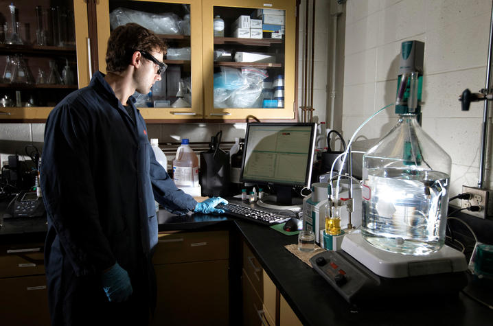 photo of young man in a lab