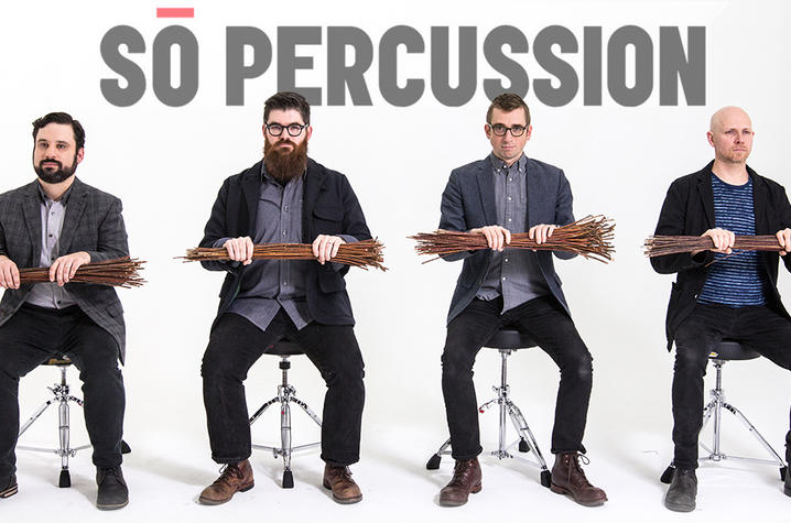 photo of Sō Percussion seated holding twigs with the band name behind them
