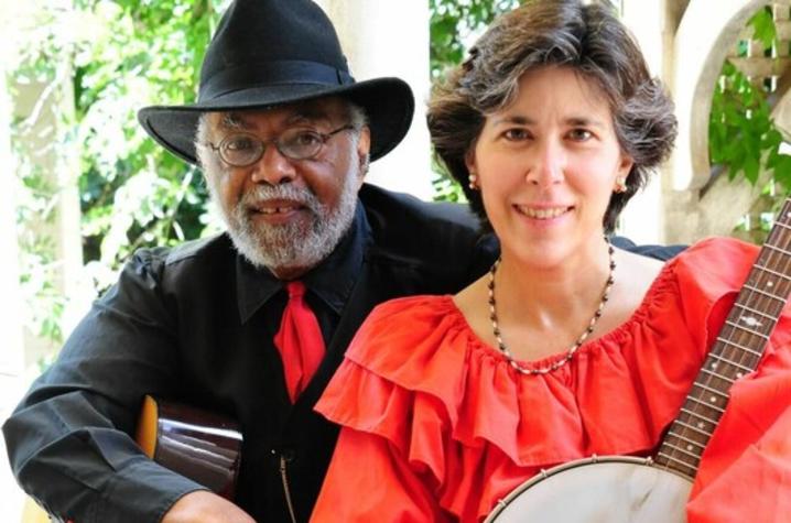 photo of Sparky and Rhonda Rucker seated holding guitar and banjo