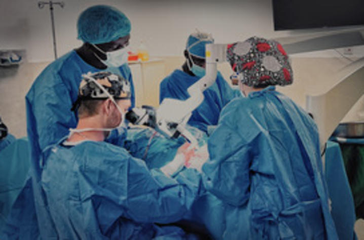 Kenyatta National Hospital resident watches Noblitt and his partner perform otologic surgery under the microscope. Photo provided by Bryce Noblitt.