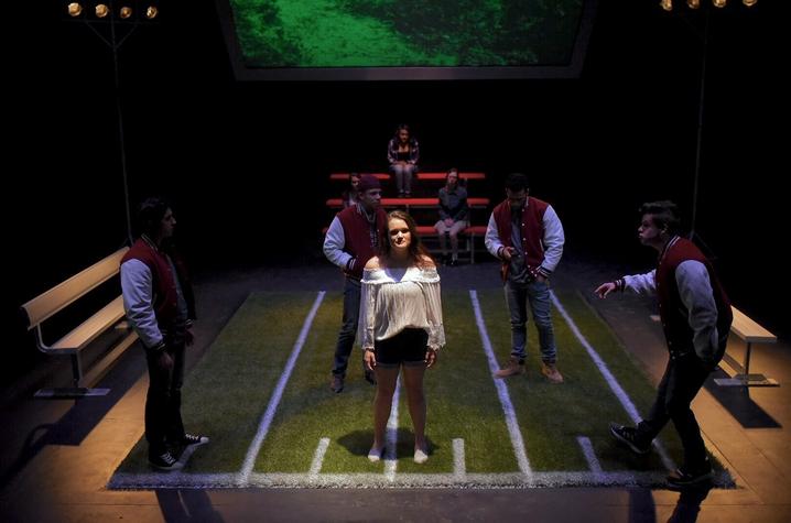 photo of girl surrounded by 4 athletes from UK Theatre's "Good Kids"