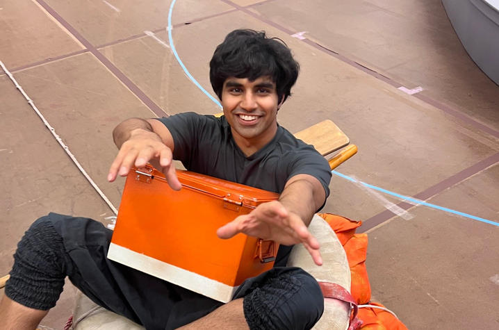 Actor sitting on a life ring on a stage