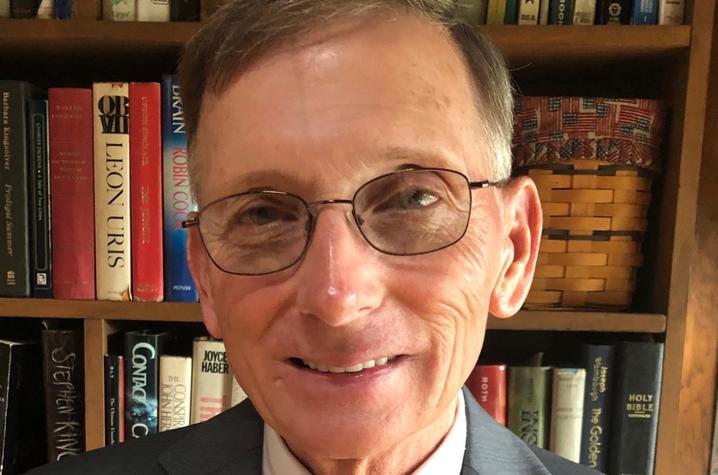 headshot photo of Donnie Wilkerson in front of bookshelf