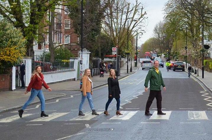 UK students from left: Catie Archambeau, Arizzona Albright and Emma Rosenzweig and Jason Swanson, UK associate professor, recreate the famous Beatles album cover at the Zebra Crossing at Abbey Road Studios in London