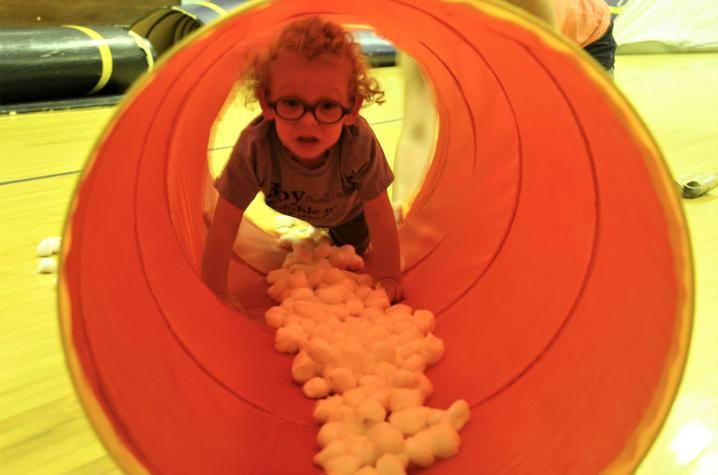 child crawling through tunnel