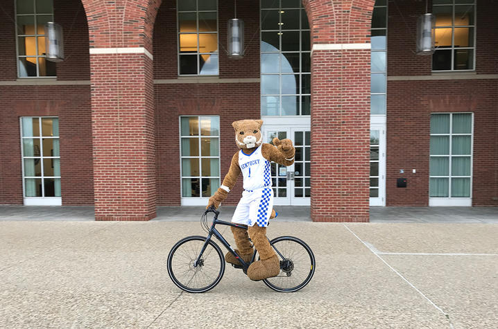 photo of UK Wildcat mascot on a bike in front of Young Library