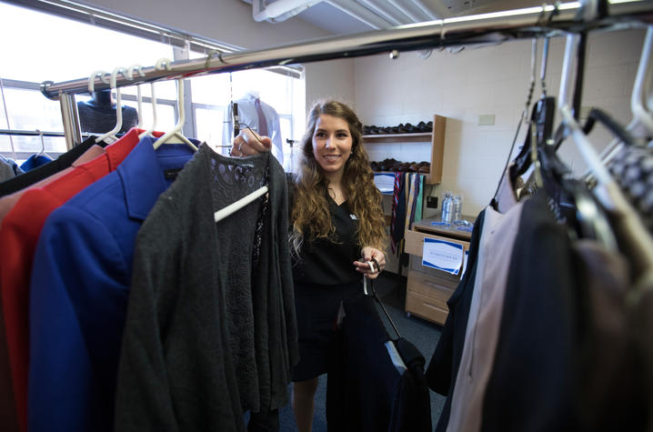 student volunteer working with clothing in Wildcat Wardrobe