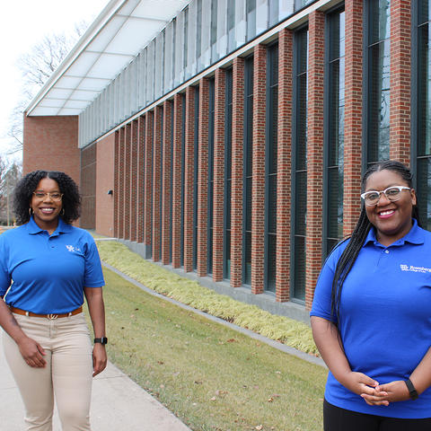 Shantale Davis and Ashlei McPherson, both first-year law students, pictures in front of the J. David Rosenberg College of Law