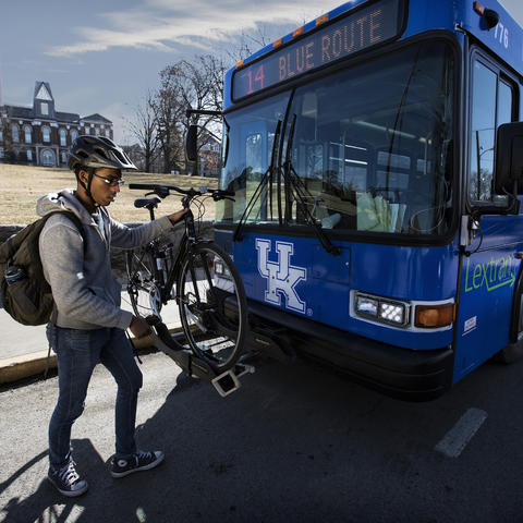 Photo of person loading bike onto transit bus