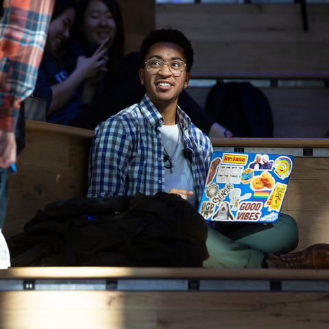 student sitting with a laptop