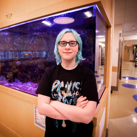 Photo of Bethany Stephens in front of fish tank in DanceBlue clinic