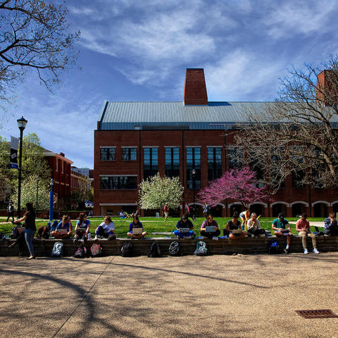 Photo of students sitting outside of Whitehall Classroom Building.
