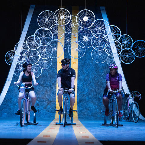 photo of 4 cast members performing in UK Theatre's "Bike America"